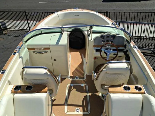 Slide: The Image of 2014 Chris-Craft Launch 25 boat interior with elegant seating and classic dashboard design. - 4