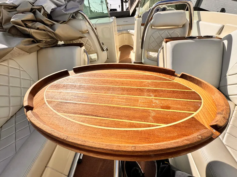 Slide: The Image of 2014 Chris-Craft Launch 25 interior with wooden table and luxurious seating. - 6