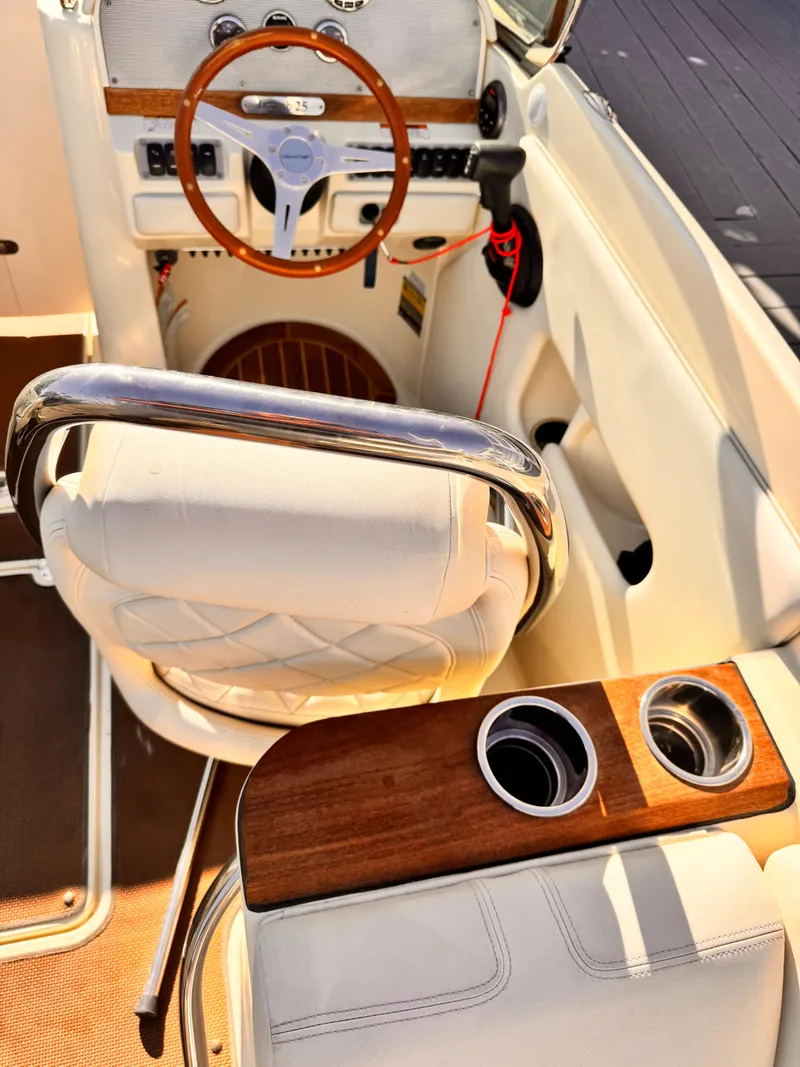 Slide: The Image of 2014 Chris-Craft Launch 25 boat interior with steering wheel and cup holders. - 8