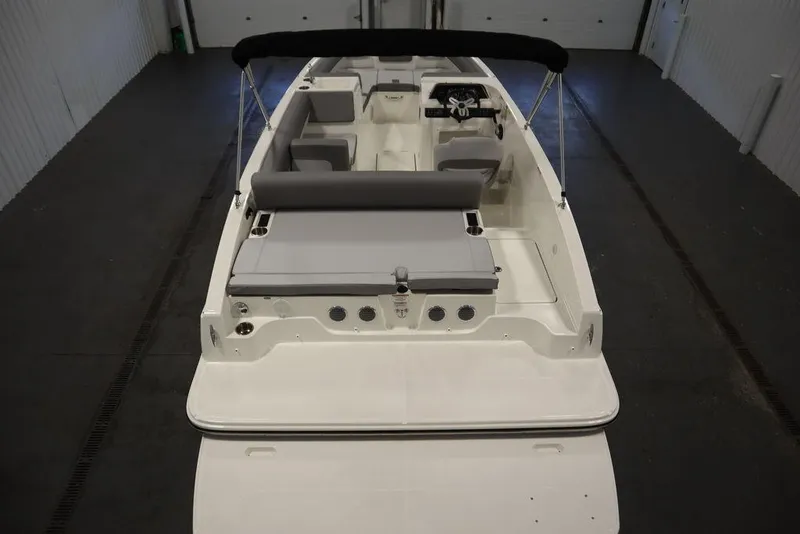 Slide: The Image of 2024 Bayliner 2050 DX boat interior with seating and steering wheel. - 10