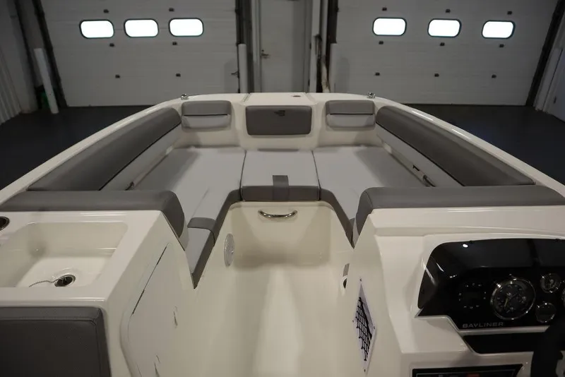 Slide: The Image of 2024 Bayliner 2050 DX boat interior with spacious seating and modern dashboard. - 11
