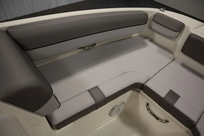 Slide: The Image of 2024 Bayliner 2050 DX boat interior seating with gray and white upholstery. - 16