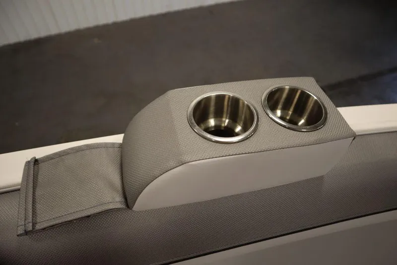 Slide: The Image of 2024 Bayliner 2050 DX boat interior with dual cup holders. - 18