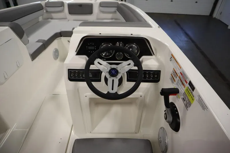 Slide: The Image of 2024 Bayliner 2050 DX boat interior with steering wheel and dashboard controls. - 21