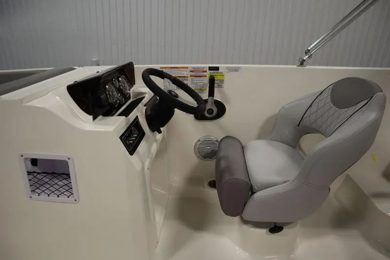 Slide: The Image of 2024 Bayliner 2050 DX boat interior with steering wheel and captain's chair. - 22