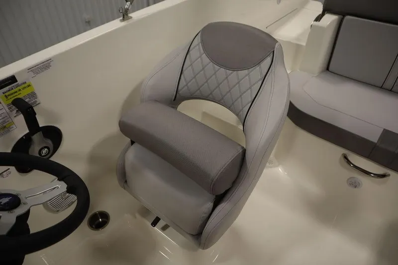 Slide: The Image of 2024 Bayliner 2050 DX boat interior with plush seating and steering wheel. - 31