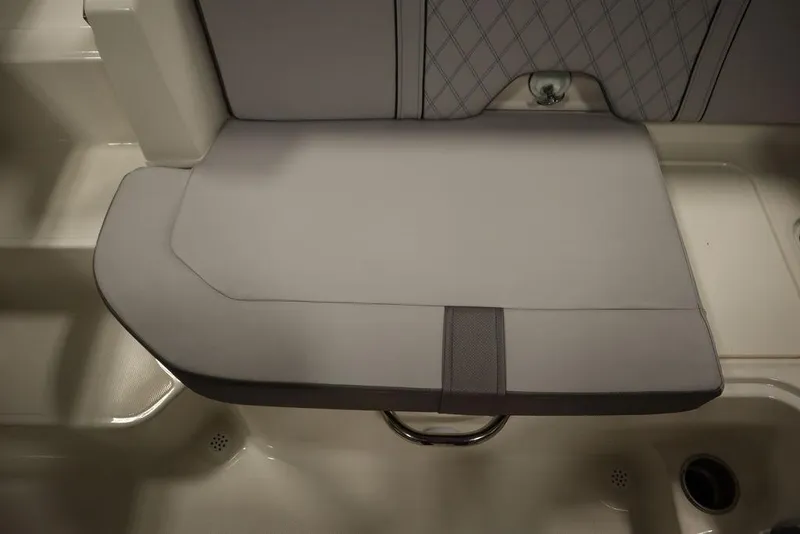 Slide: The Image of 2024 Bayliner 2050 DX boat seat with gray upholstery and diamond pattern. - 42