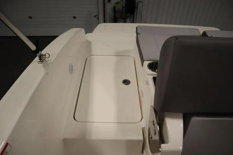 Slide: The Image of 2024 Bayliner 2050 DX boat interior with seating and storage compartment. - 48