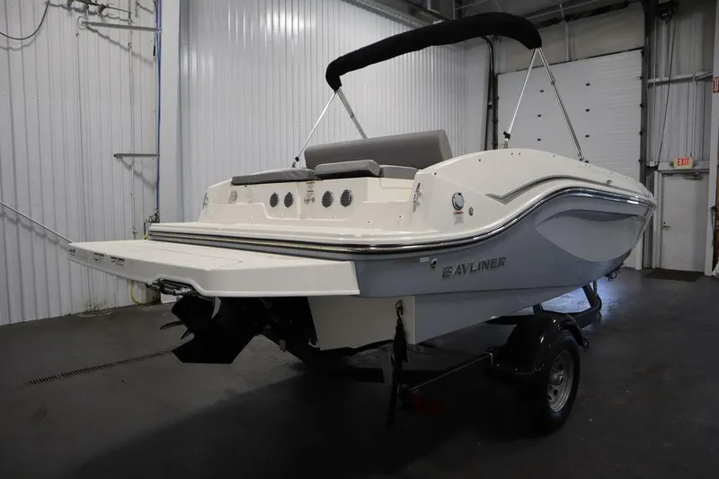 Slide: The Image of 2024 Bayliner 2050 DX boat in a garage, rear view. - 5