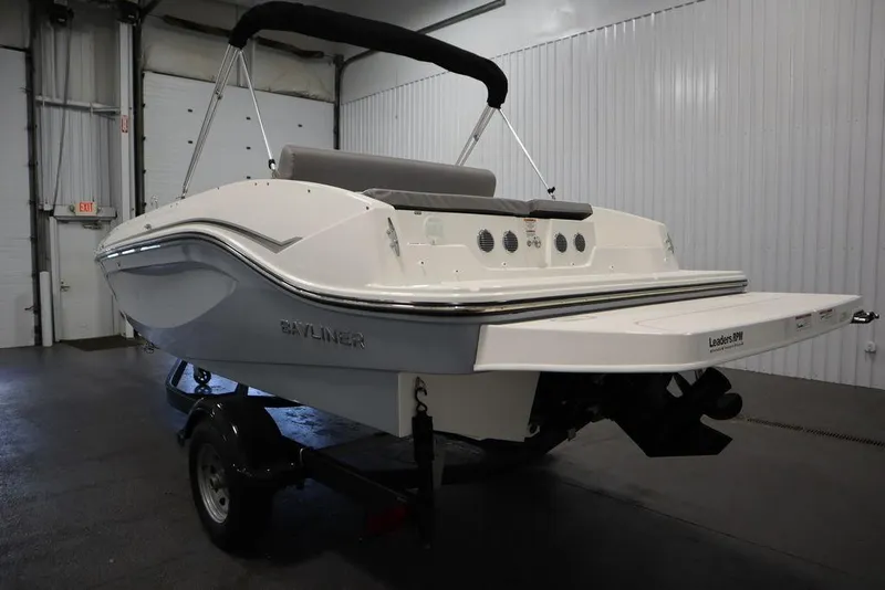 Slide: The Image of 2024 Bayliner 2050 DX boat in a showroom, rear view. - 7