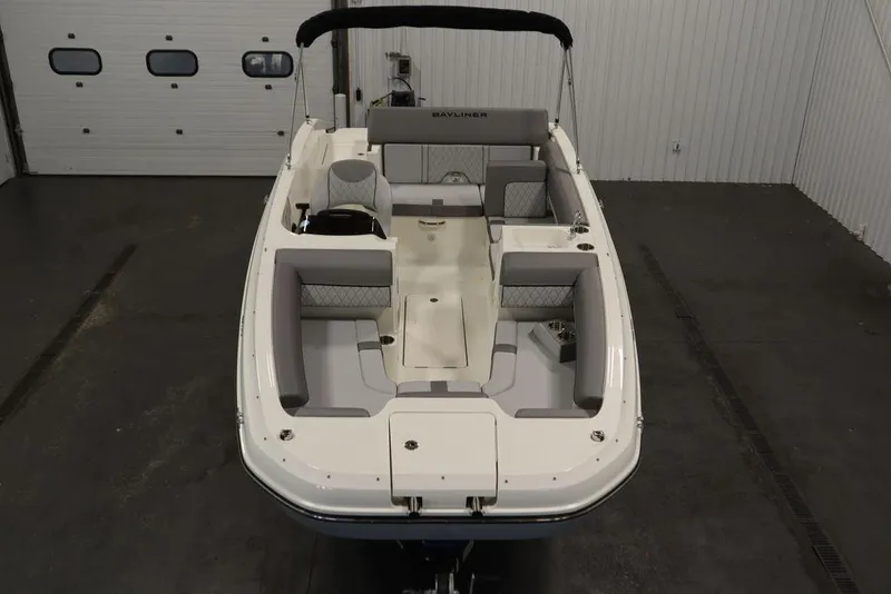 Slide: The Image of 2024 Bayliner 2050 DX boat, spacious interior, sleek design, white and gray seating. - 9