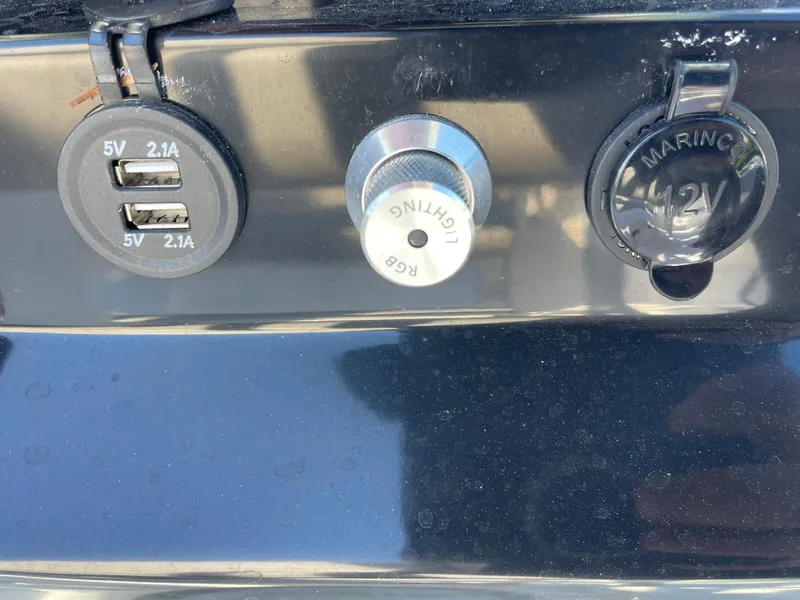 Slide: The Image of USB ports and marine power outlet on 2023 Wellcraft 222 Fisherman boat. - 10