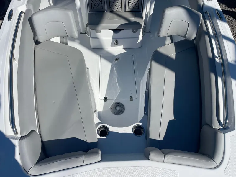 Slide: The Image of 2023 Wellcraft 222 Fisherman boat interior with gray seating and storage compartments. - 19