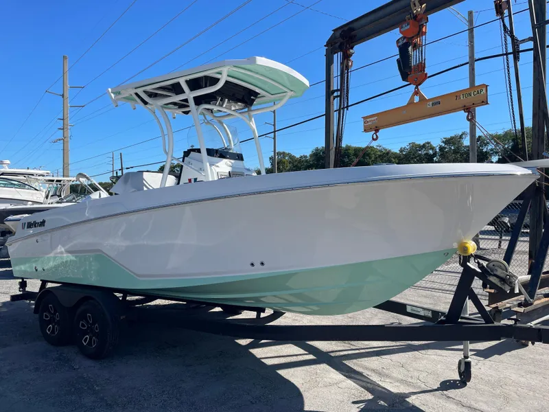 Slide: The Image of 2023 Wellcraft 222 Fisherman boat on trailer, displayed outdoors. - 3