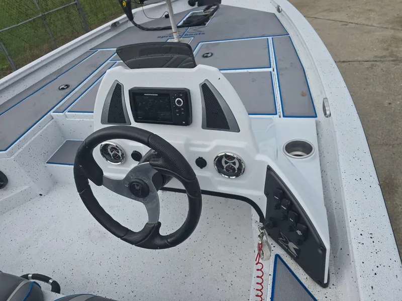 Slide: The Image of 2022 Xpress H18 boat dashboard with steering wheel and control panel. - 12