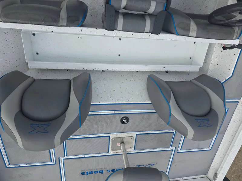 Slide: The Image of Interior of 2022 Xpress H18 boat with gray and blue seating. - 14