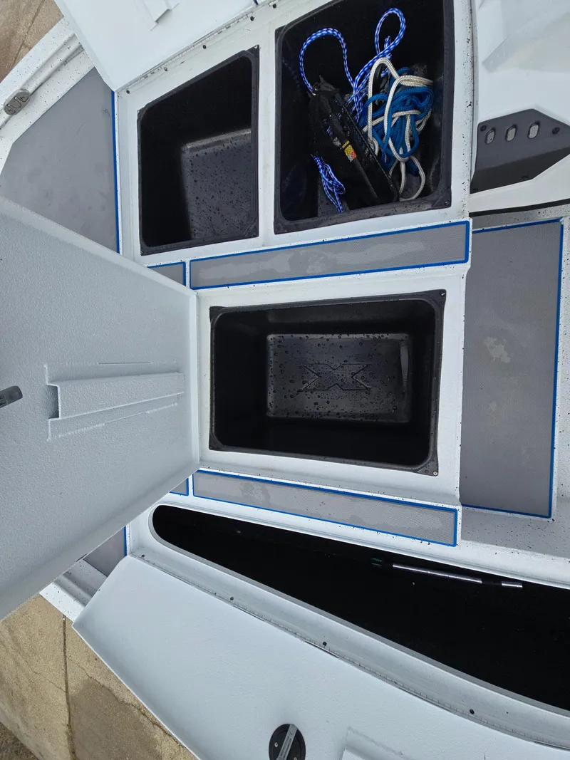 Slide: The Image of Open storage compartments on 2022 Xpress H18 boat deck. - 15