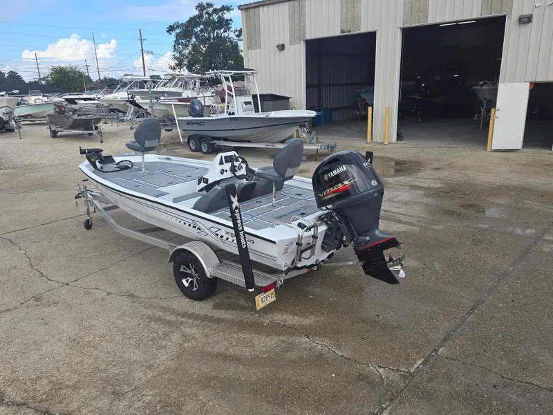 Slide: The Image of 2022 Xpress H18 boat with Yamaha motor parked outside a warehouse. - 7