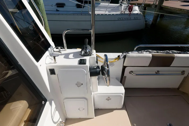 Slide: The Image of 2015 Ranger Tugs R-29S helm station with steering wheel and controls. - 10