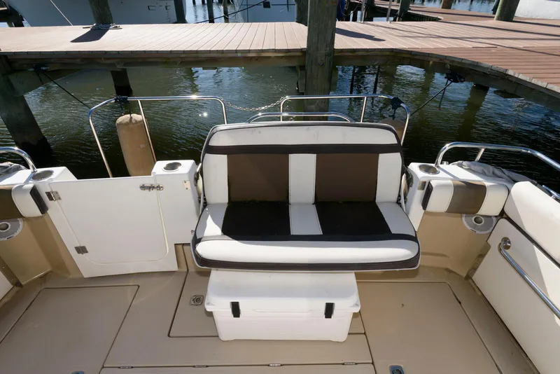 Slide: The Image of 2015 Ranger Tugs R-29S boat seating area with black and white cushions. - 11