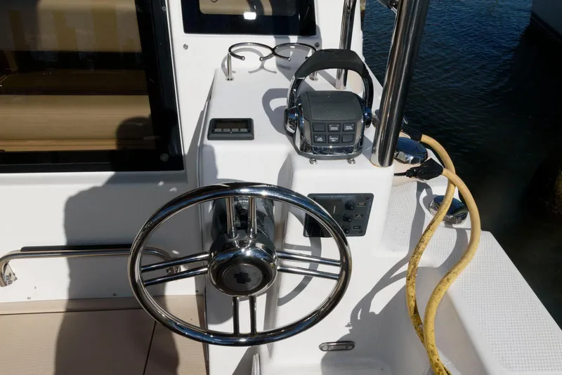Slide: The Image of 2015 Ranger Tugs R-29S helm with steering wheel and controls. - 12