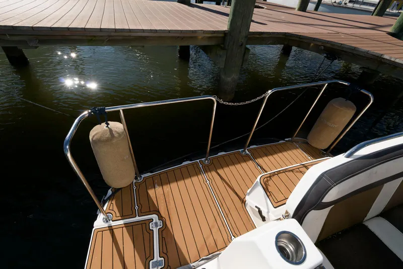 Slide: The Image of Ranger Tugs R-29S 2015 boat deck with wooden flooring and dock view. - 13