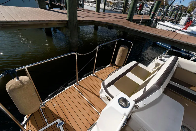 Slide: The Image of 2015 Ranger Tugs R-29S boat deck with seating and dock view. - 14
