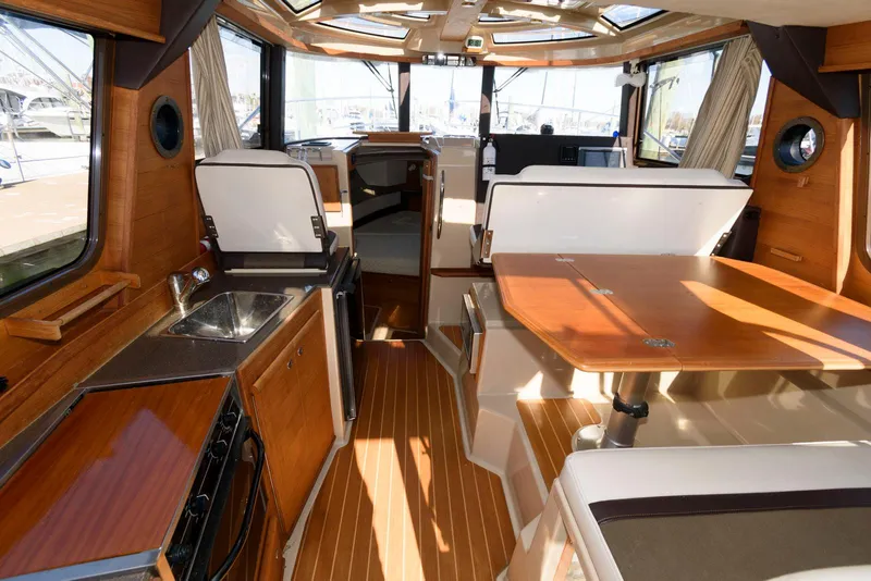 Slide: The Image of Interior of 2015 Ranger Tugs R-29S boat with wood finishes and seating area. - 16