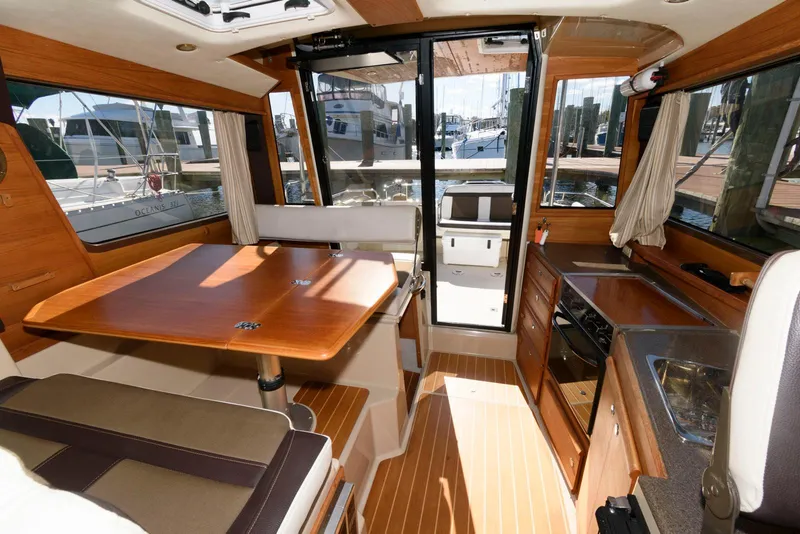 Slide: The Image of Interior of 2015 Ranger Tugs R-29S boat with wood finishes and dining area. - 20