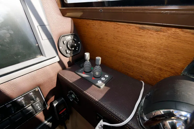 Slide: The Image of Control panel of 2015 Ranger Tugs R-29S boat with joysticks and switches. - 24