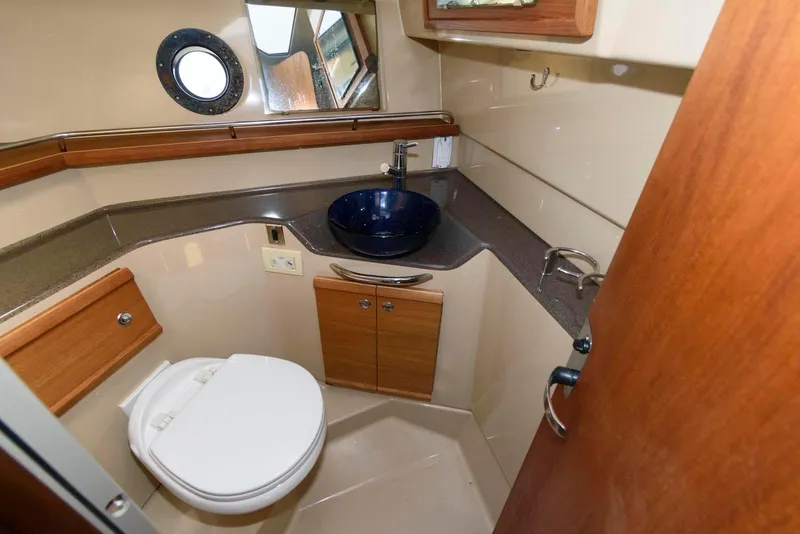 Slide: The Image of 2015 Ranger Tugs R-29S bathroom with modern sink, toilet, and wood accents. - 27