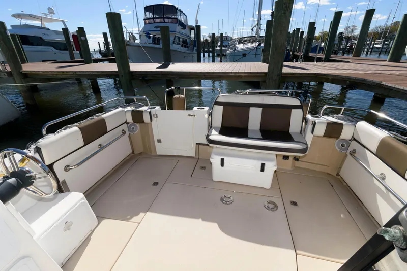 Slide: The Image of 2015 Ranger Tugs R-29S boat interior with seating, docked at marina. - 7