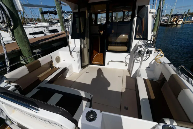 Slide: The Image of 2015 Ranger Tugs R-29S boat interior with seating, docked at marina. - 9