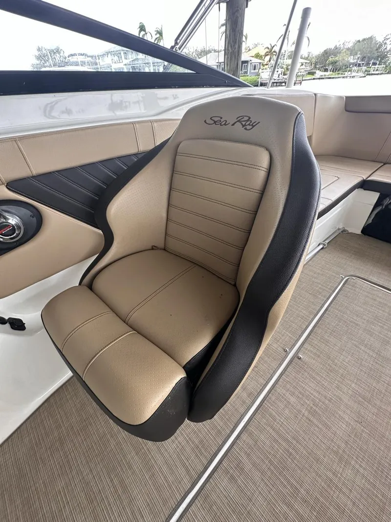 Slide: The Image of 2019 Sea Ray SPX 230 OB boat seat with tan upholstery and logo. - 12