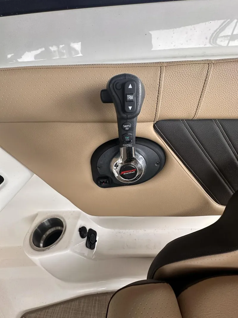 Slide: The Image of 2019 Sea Ray SPX 230 OB throttle control on beige interior panel. - 13