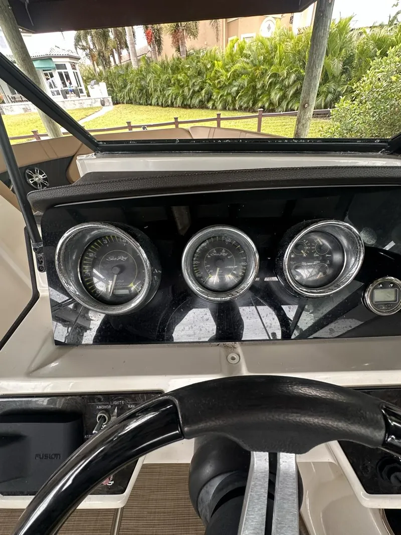 Slide: The Image of Dashboard of 2019 Sea Ray SPX 230 OB boat with gauges and steering wheel. - 16