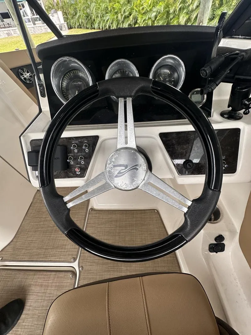 Slide: The Image of 2019 Sea Ray SPX 230 OB steering wheel and dashboard interior. - 17