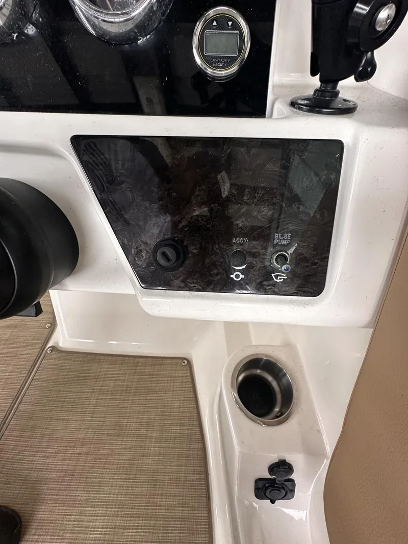 Slide: The Image of Control panel of 2019 Sea Ray SPX 230 OB boat with cup holder. - 18