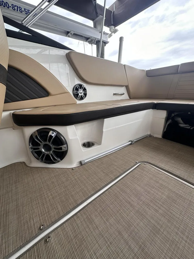 Slide: The Image of 2019 Sea Ray SPX 230 OB boat interior with beige seating and speaker system. - 19
