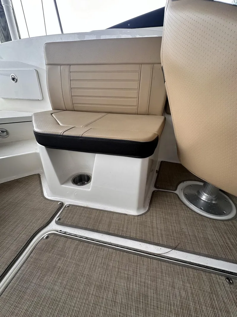 Slide: The Image of 2019 Sea Ray SPX 230 OB boat interior seating with beige upholstery. - 20