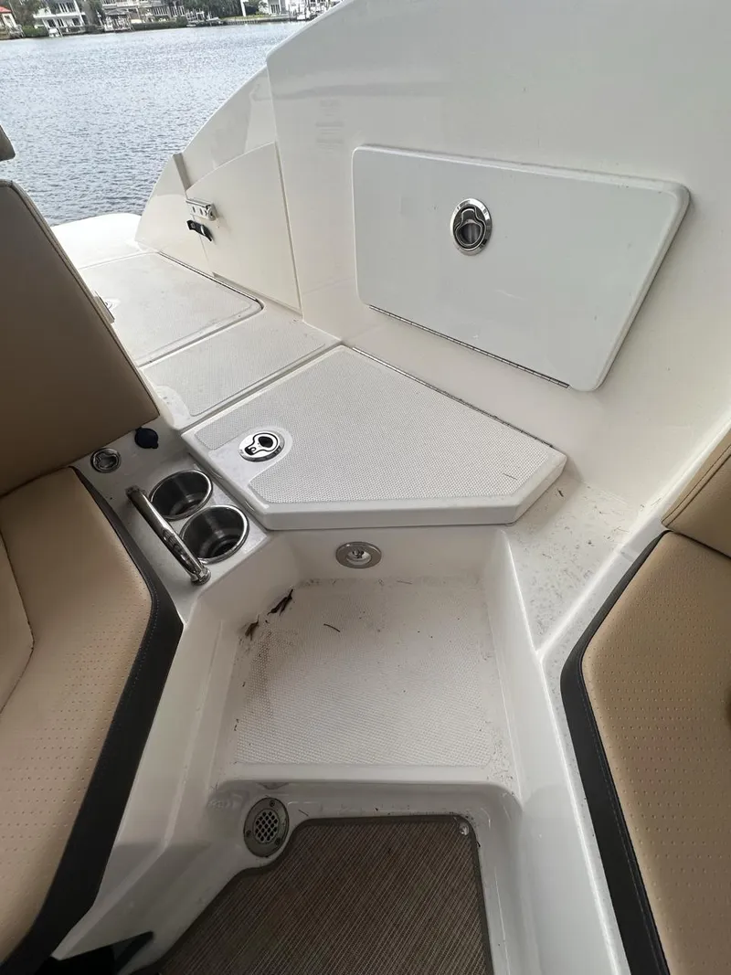 Slide: The Image of 2019 Sea Ray SPX 230 OB boat interior with seating and storage compartments. - 21