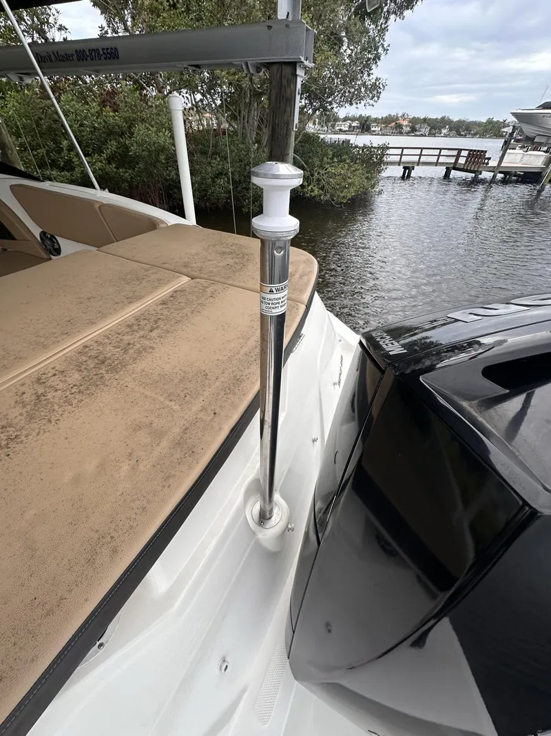 Slide: The Image of 2019 Sea Ray SPX 230 OB boat docked by a lake. - 27
