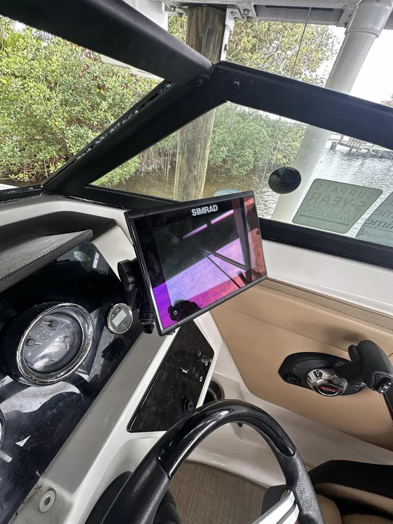 Slide: The Image of 2019 Sea Ray SPX 230 OB dashboard with Simrad display and steering wheel. - 30