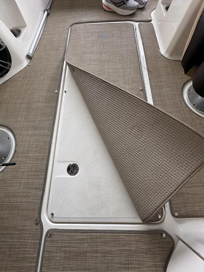 Slide: The Image of 2019 Sea Ray SPX 230 OB boat interior with carpeted flooring detail. - 31