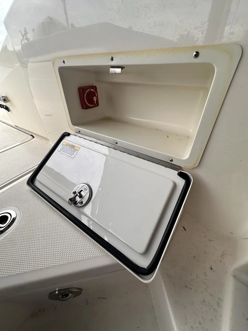 Slide: The Image of 2019 Sea Ray SPX 230 OB storage compartment with open hatch. - 32