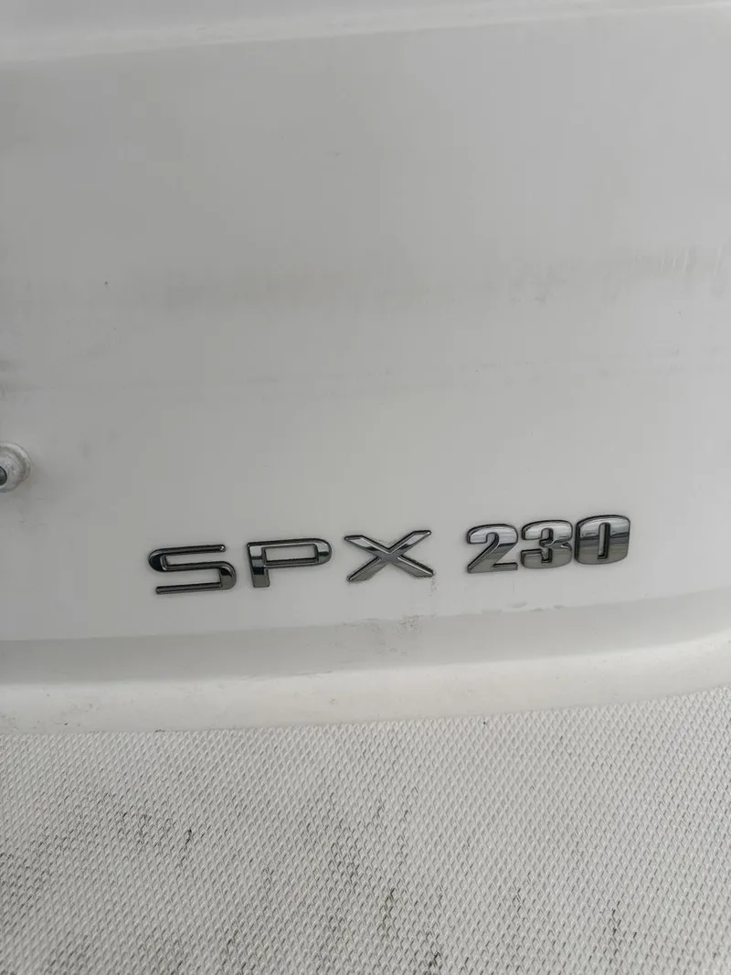 Slide: The Image of 2019 Sea Ray SPX 230 OB boat model emblem on white surface. - 33