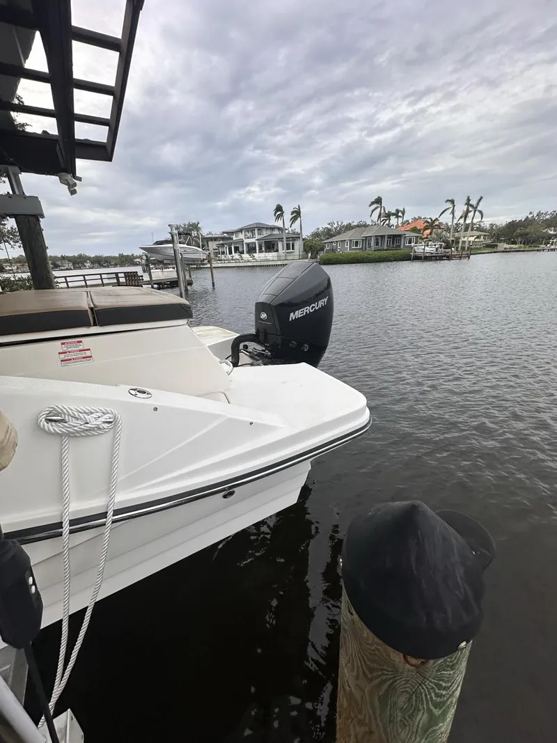 Slide: The Image of 2019 Sea Ray SPX 230 OB boat docked on a calm waterfront. - 37