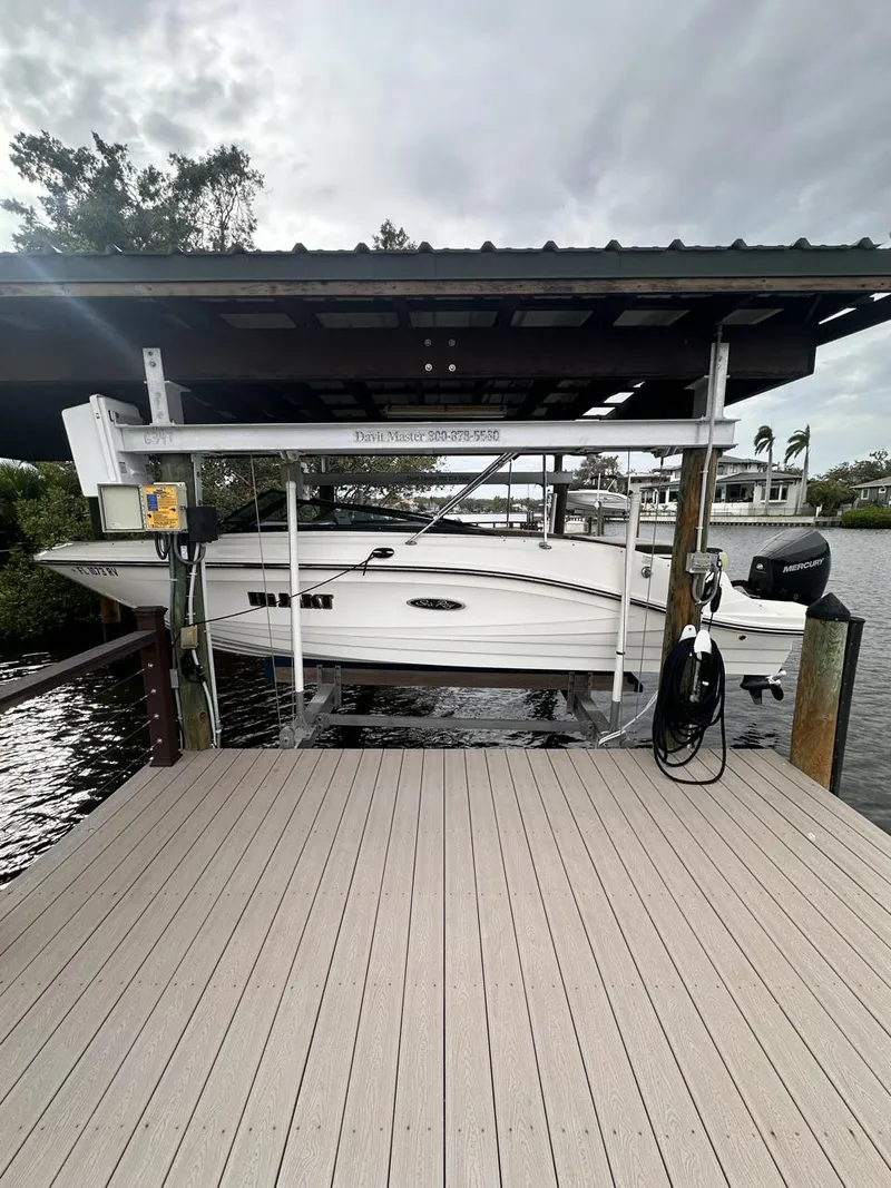 Slide: The Image of 2019 Sea Ray SPX 230 OB boat docked under covered lift. - 38