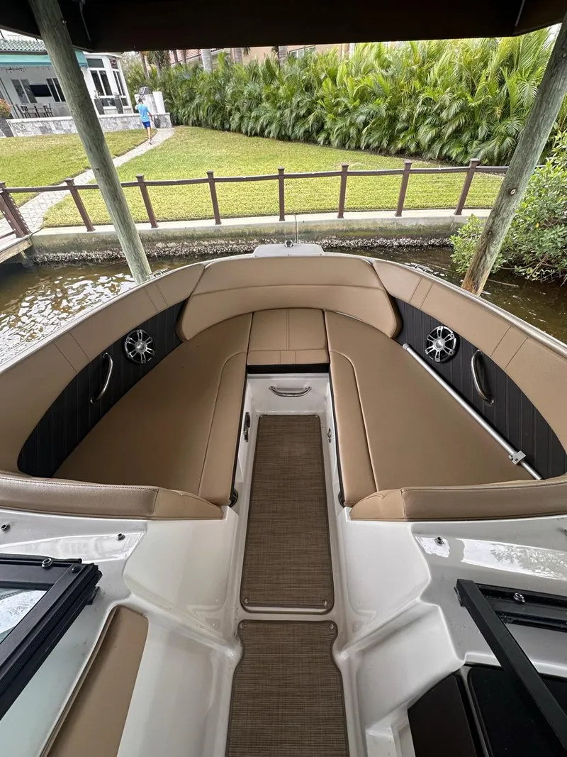 Slide: The Image of 2019 Sea Ray SPX 230 OB boat interior with tan seating and sleek design. - 4