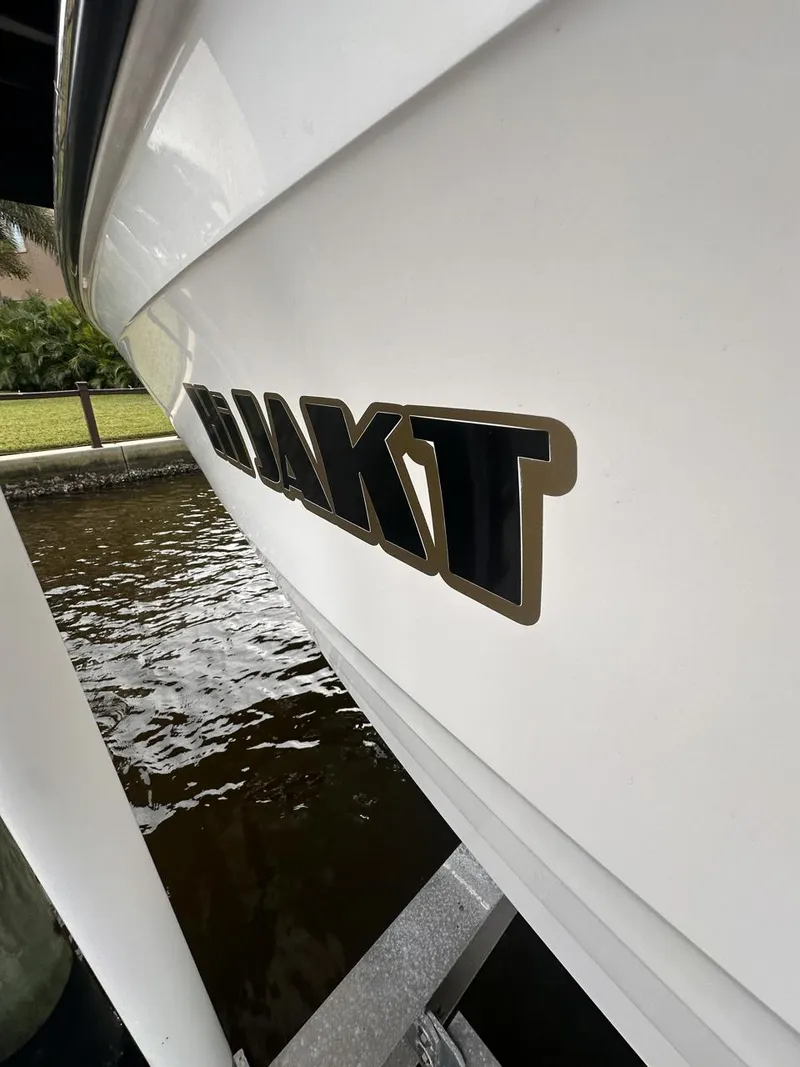 Slide: The Image of 2019 Sea Ray SPX 230 OB boat side view near water. - 40